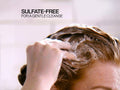 Redken Shampoo being lathered in wet hair.