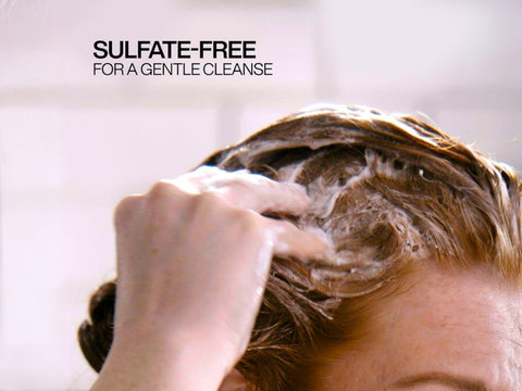 Redken Shampoo being lathered in wet hair.