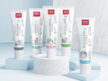 Collection of Splat toothpaste tubes on a light blue background