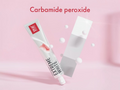 Tube of Extreme White toothpaste with carbamide peroxide text on a pink background