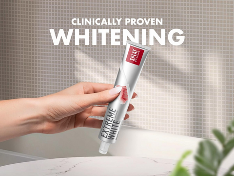 Hand holding a tube of Extreme White toothpaste with 'Clinically Proven Whitening' text.