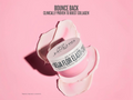Jar of skincare product with 'Sculpted Flora' branding on a pink background