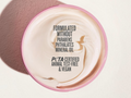 Cosmetic container with PETA certification text on a light background