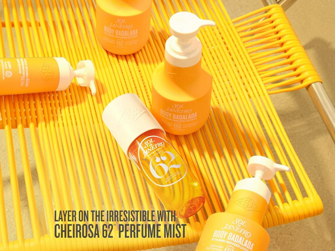 Orange and white bottles with pump dispensers on a yellow woven surface.