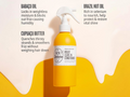 Yellow bottle of hair conditioner with text about ingredients on a beige background