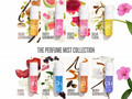 Perfume mist collection with various scents and colorful packaging on a white background.