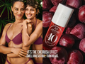 Two women in purple lingerie with a bottle of Sol Janeiro Cheirosa 40 against plums.