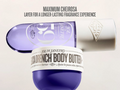 Blue and white body butter with Sol de Janeiro branding on a light beige background