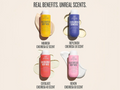 Four bottles of different scented body washes with labels on a beige background.