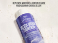 Sol de Janeiro Delicia Drench Shower Oil bottle on a textured white background