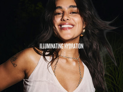 Woman with 'ILLUMINATING HYDRATION' text overlay against a dark background