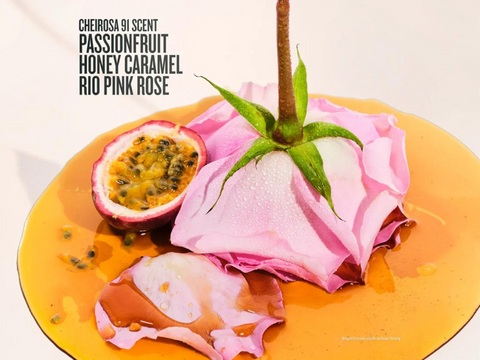 Decorative item with passionfruit, pink rose petals, and honeycomb on a yellow plate against a white background.