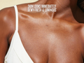 Close-up of a person's shoulder with text about skin appearance