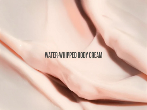 Close-up of water-whipped body cream with a soft focus background