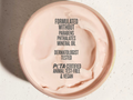 Cosmetic product lid with certification text on a light background