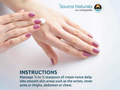 Hand holding a small container of cream with Source Naturals branding and instructions.