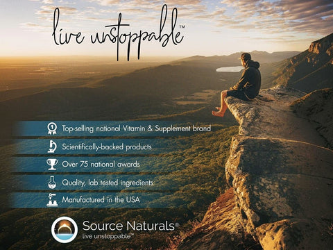 Person sitting on a cliff overlooking a scenic landscape with Source Naturals advertisement.