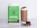 Chocolate rice protein powder being blended into a shake.
