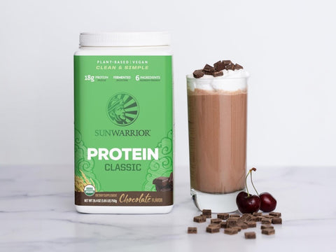 Chocolate rice protein powder being blended into a shake.