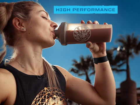 Sunwarrior chocolate protein powder being mixed in a shaker bottle.