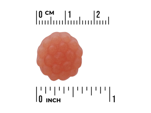 Gummy raspberry with a ruler for scale on a white background