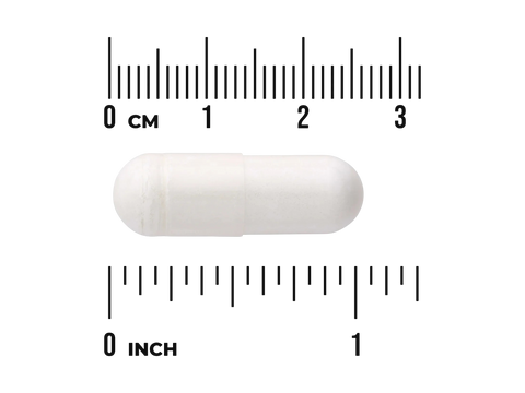 White capsule pill with a ruler for scale on a white background
