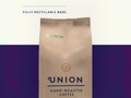Union Hand-Roasted Coffee bag with recyclable label on a gradient background