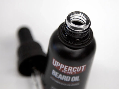 Uppercut Deluxe Beard Oil 30ml bottle angled view showing dropper cap and 30ml size