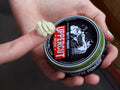 Uppercut Deluxe Matte Pomade 100g top lid view showing product branding and 100g size