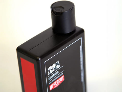 Uppercut Deluxe Strength and Restore Conditioner 240ml bottle angled view showing 240ml size