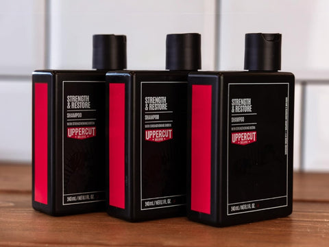 Uppercut Deluxe Strength and Restore Shampoo 240ml front view of shampoo bottle with branding