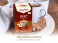 Yogi Tea Ginger tea box with a cup of tea on a wooden surface