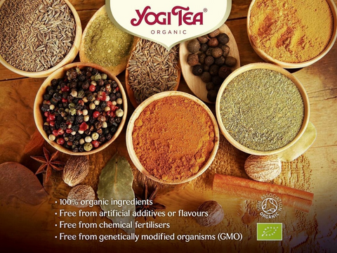 Yogi Tea organic spices and herbs with brand logo and product details on a wooden background