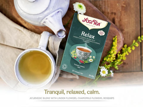 Yogi Tea Relax packaging with a cup of tea and teapot on a wooden surface.