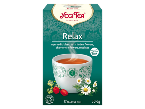 Yogi Tea Relax tea box with a cup of tea and tea leaves on a white background