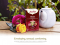 Yogi Tea Rose package with a teapot and flowers on a wooden surface